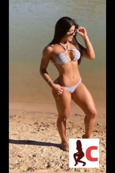 hot brunette Tyrone escort poses on the beach