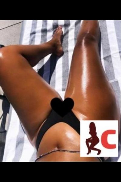 hot oiled Tyrone escort on a sun lounger