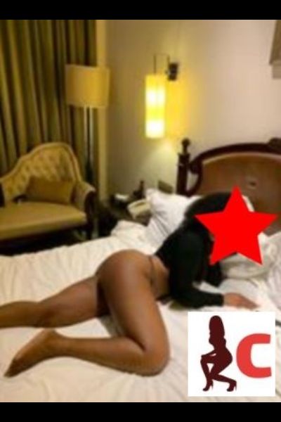 tanned Tyrone escort laid on her bed