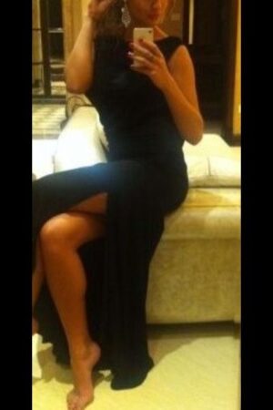 Mature Blonde London Escort in flowing black evening dress