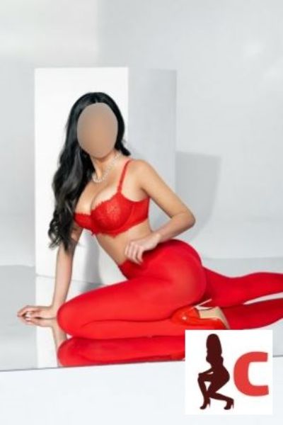 gorgeous Derry escort posing in flowing red dress