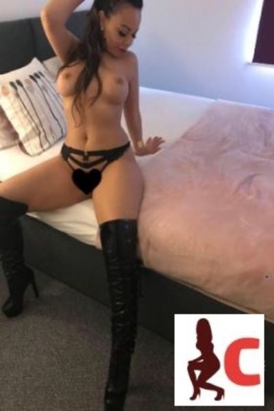Cork escort sitting on bed flashing tits