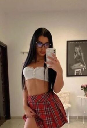 young St Andrews escort in glasses and plaid mini skirt