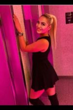 smiling blonde Dundee escort in the toilet