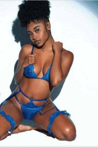 posing ebony Derby Escort in blue lingerie
