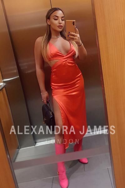 Sexy Teen London Escort in orange dress