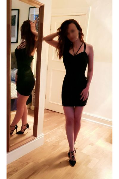 Natalia European Cardiff Escort posing in a black dress