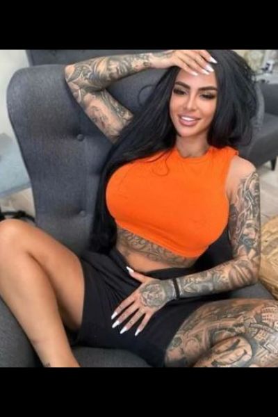 Busty Escort in Bangor in tight orange top