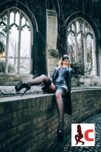 Alexandra Wildfire in bondage gear in a church