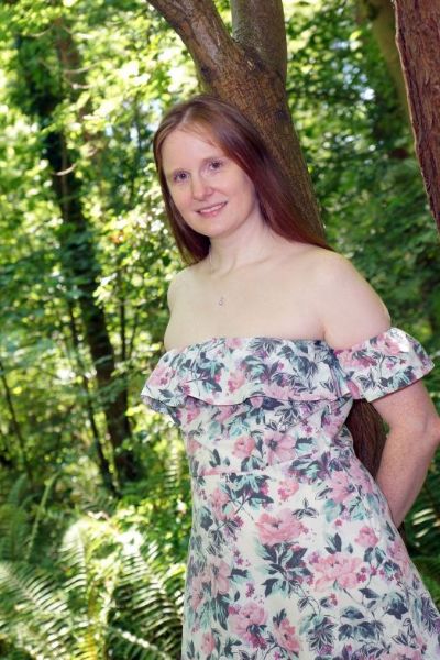 Auburn Delight in a floral dress outside
