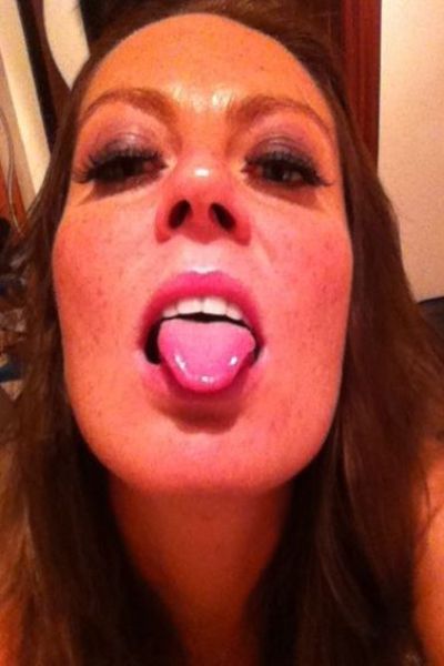 Alexis May sticking out her tongue