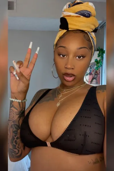 Busty ebony escort doing the peace sign