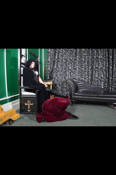 Mistress Vixen Glasgow in a cloak with a slave