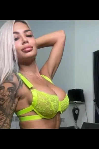 Deea Lux Noblehill Escort in bright yellow bra with pert tits