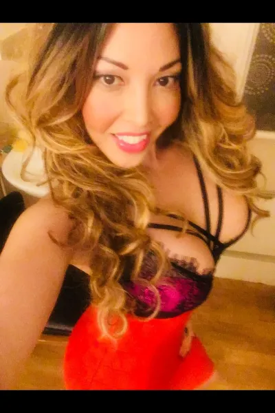rio lee escort looking busty in a red dress