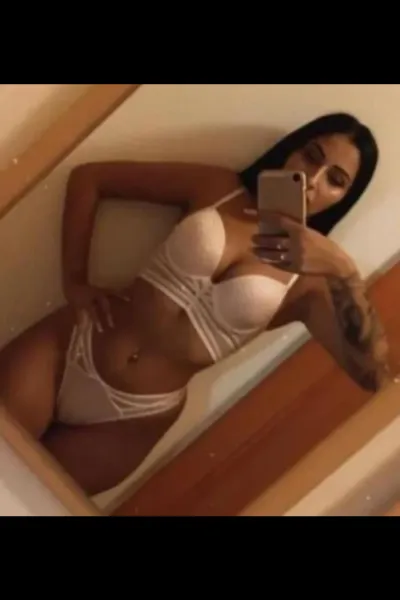 Brunette Harrogate Escort taking selfie in white lingerie