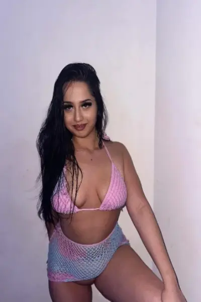 Dark haired escort in a pink bikini