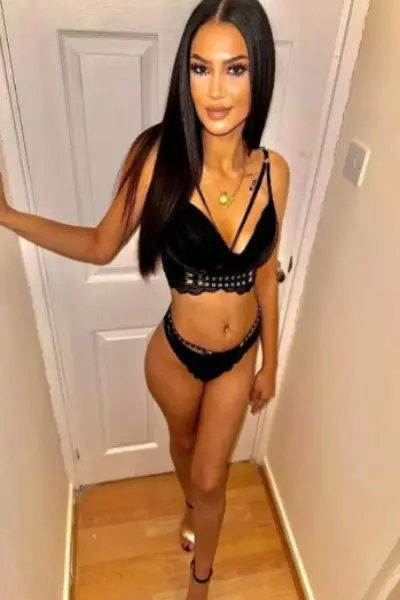 Petite brunette escort in black lingerie