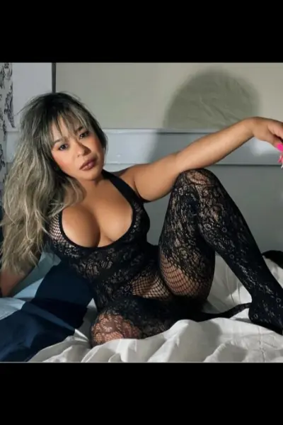 Busty Brazilian escort in black lingerie