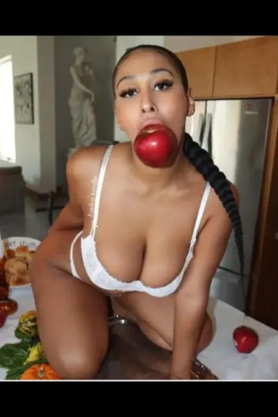 Peckham escort in white bra with an apple in her mouth