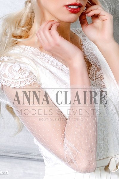 Blonde escort in white dress