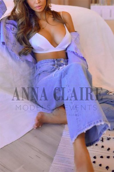 Brunette escort in oversized denim outfit