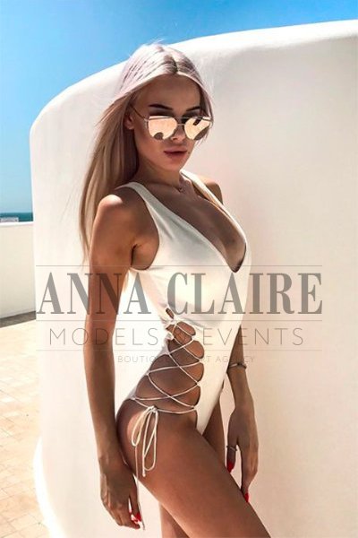 Blonde escort in white swimwear