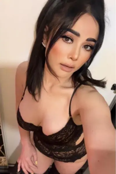 Dark haired Asian escort in black lingerie