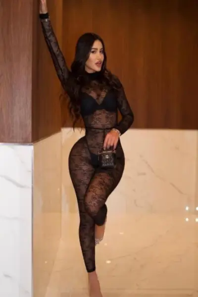 Brunette escort in a sheer black bodysuit
