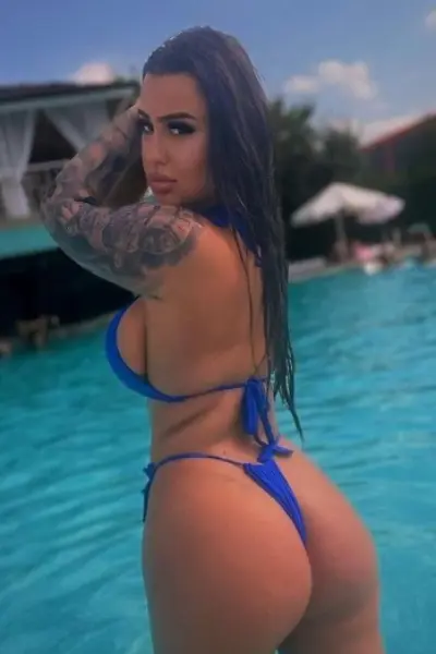 Blackburn escort in the pool in a blue bikini