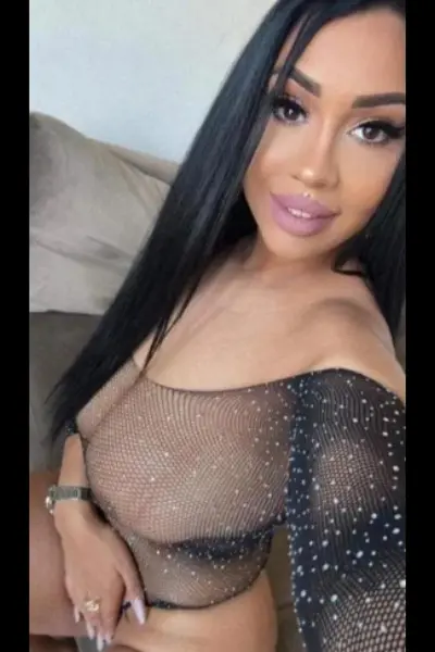 Busty dark haired escort in black lingerie