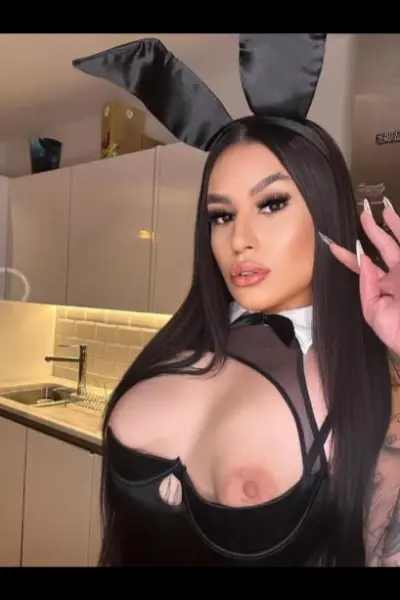 Tattooed topless Hammersmith escort in a bunny outfit
