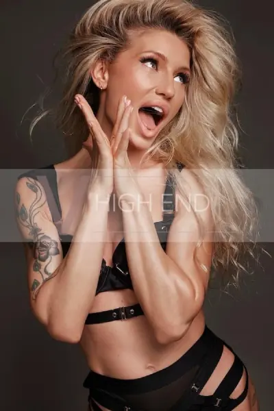 Petite blonde escort in black lingerie