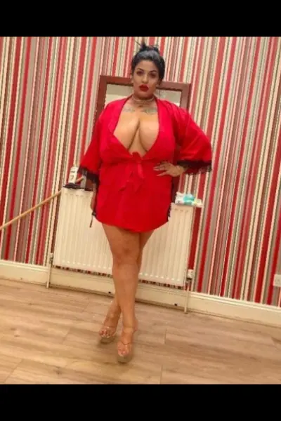 Super busty tattooed escort in a red robe
