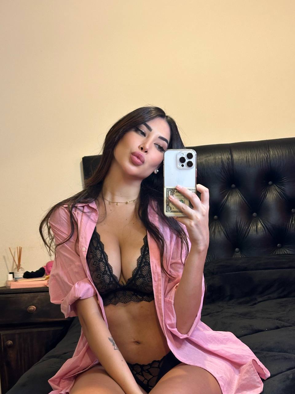Sexy brunette escort taking a selfie