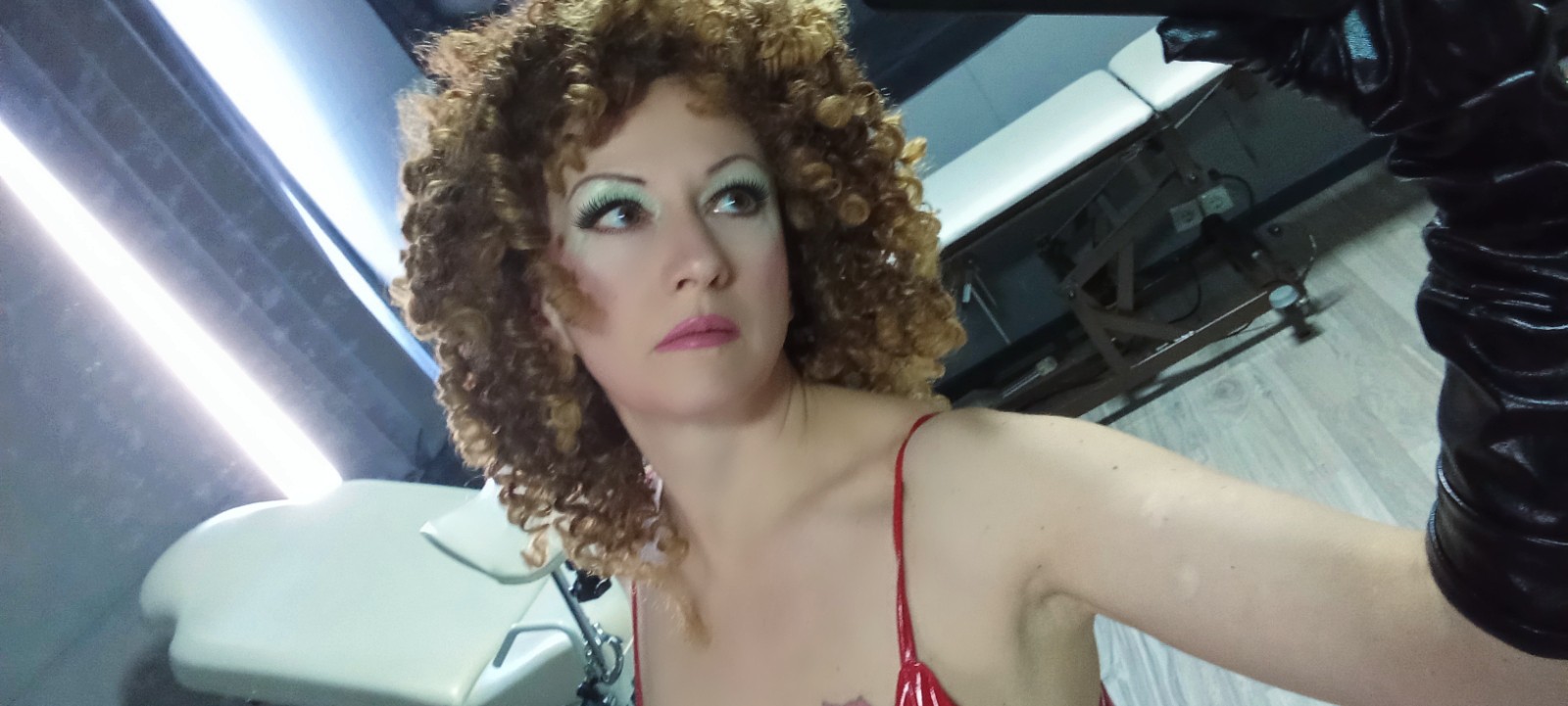 Curly haired escort taking a selfie
