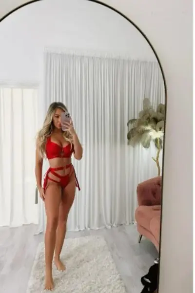 Stunning blonde escort in red lingerie