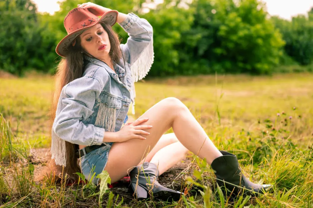 Cowgirl girl laid on the grass