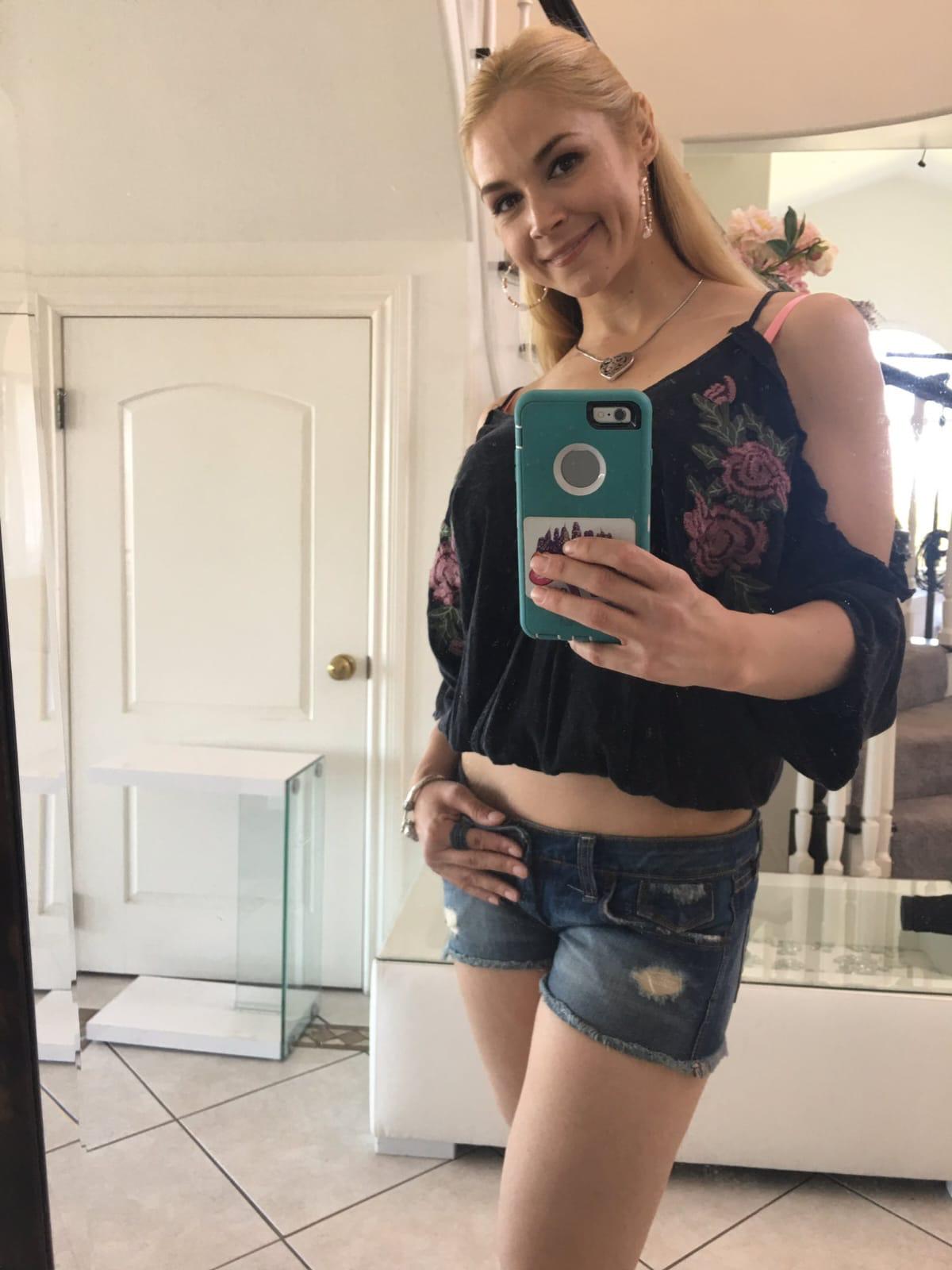 Blonde escort taking a selfie