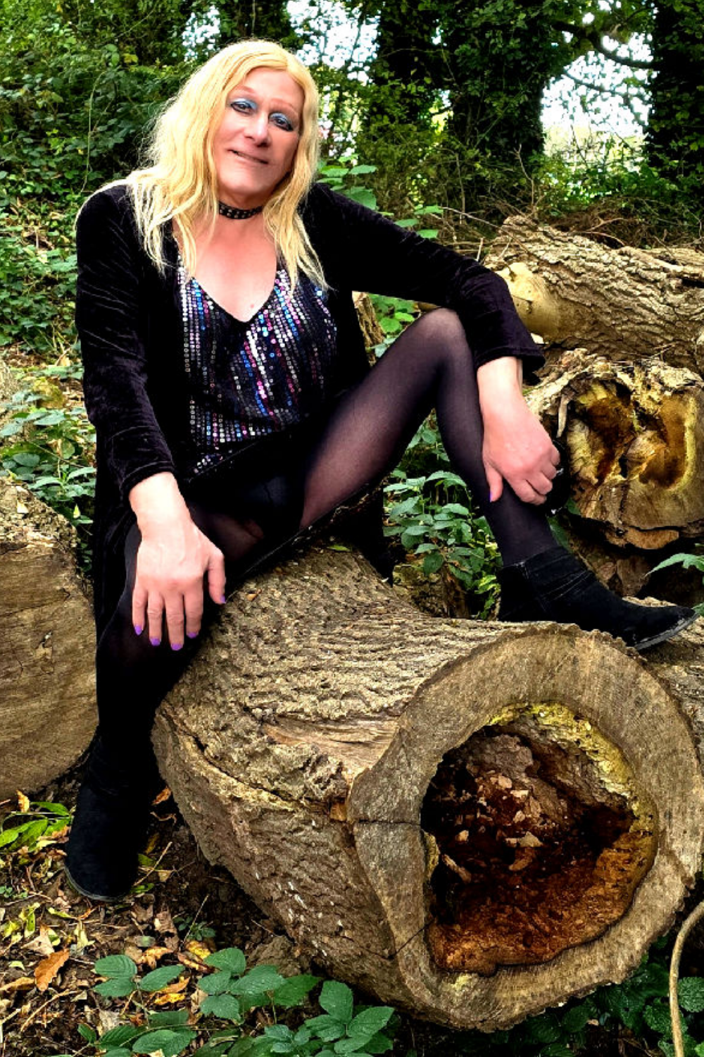 Blonde TS escort posing in a wood