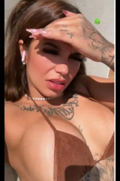 Super busty escort in a brown bikini