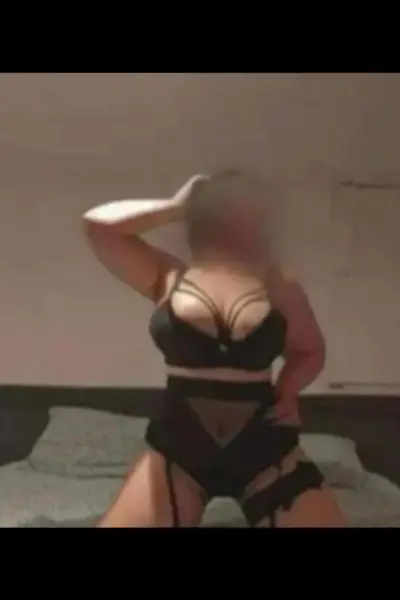 Busty blonde escort in black lingerie
