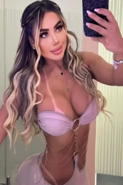 Busty Brazilian escort taking a selfie