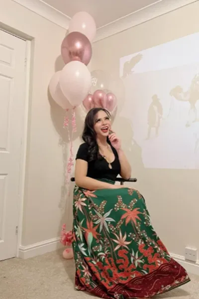 Ladyboy Jasmine TS sat in front of balloons