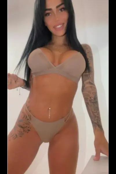 Busty and petite Brighton escort in beige lingerie