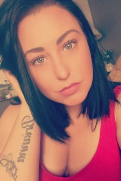 Brunette Cork Escort in a red vest