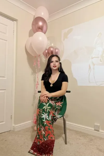Ladyboy Jasmine TS sat in front of balloons
