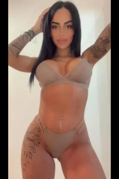 Busty and petite Brighton escort in beige lingerie