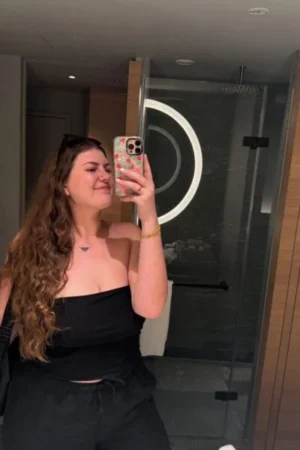 Brunette Bath escort taking a selfie in a bathroom