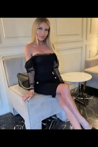 Blonde Edinburgh escort in a black dress